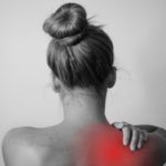 Woman with visual pain on back on right shoulder