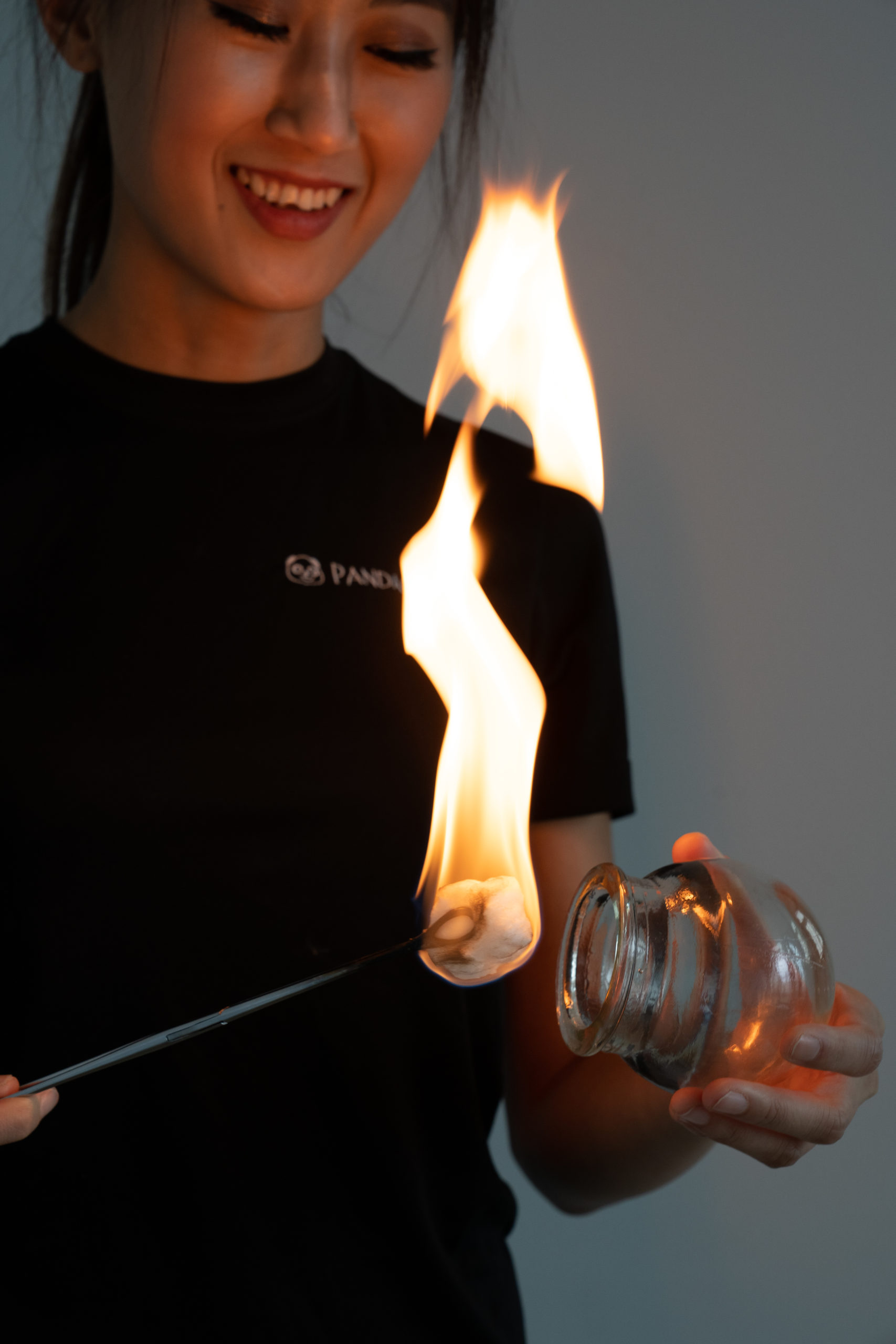 front view of therapist preparing cup with fire
