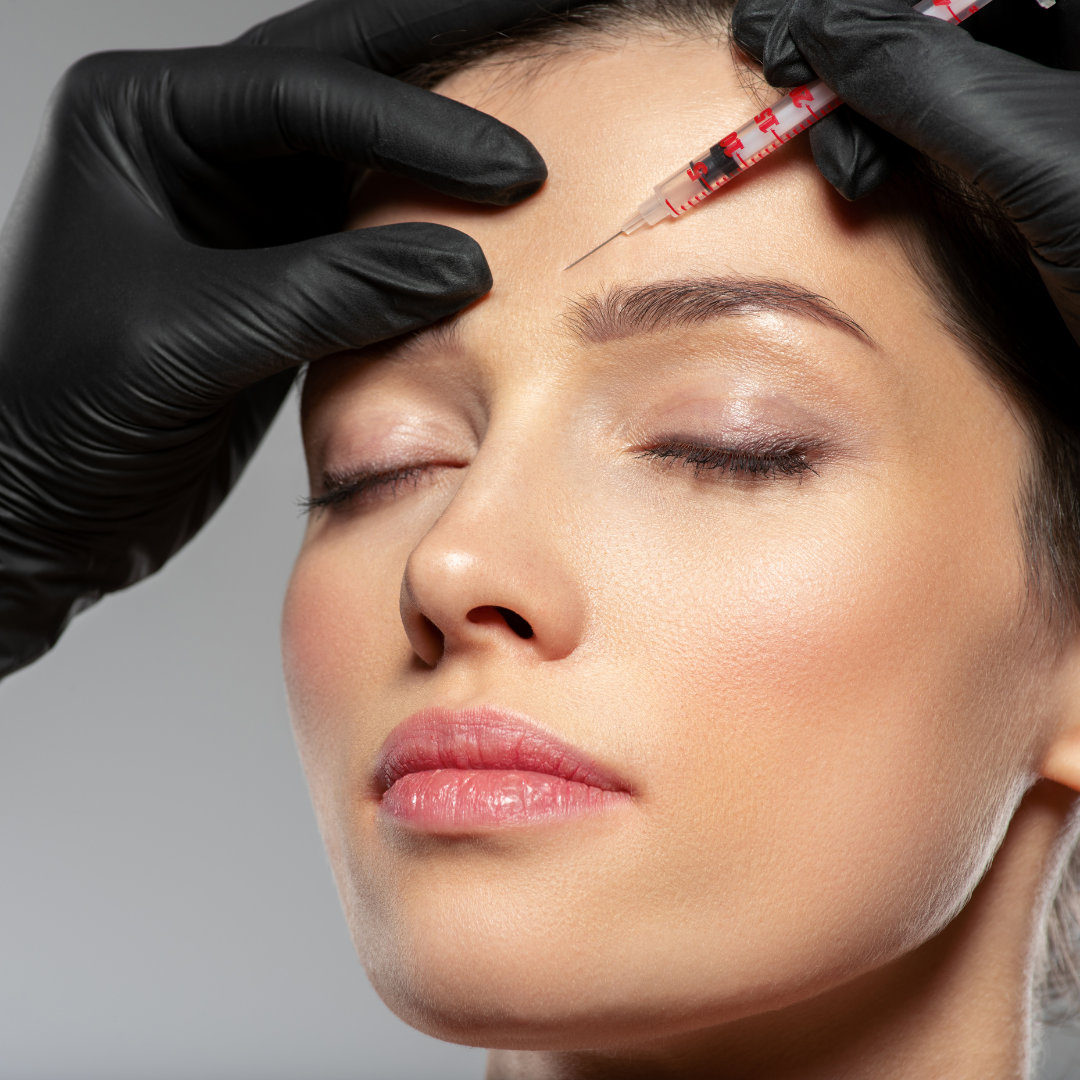 Botox needle injection performed above left eyebrow