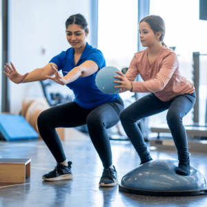 woman doing pilates lunges in front of a mirror