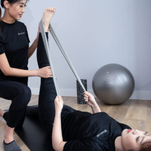 three women in a pilates class practicing forward lunges