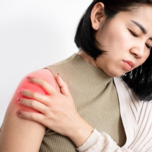 Woman holding lower back in pain with red highlight down her leg – showing signs of sciatica, treatable with RMT in Burnaby.