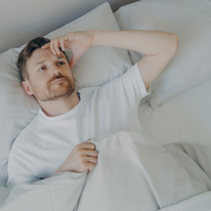 Man holding foot in pain due to plantar fasciitis – seeking RMT treatment in Burnaby for foot and heel relief.